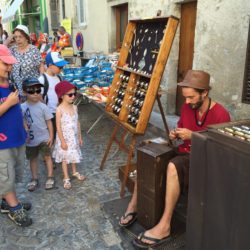 Jeweler working at open air market in Dieulefit, France.